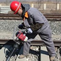 Railway workers are compacting the stone materials of the railway track bed